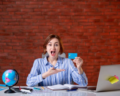 front-view-travel-agent-her-working-place-holding-credit-card-map-indoors-manager-worker-service-operator-world-money-agency-document
